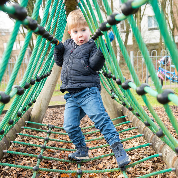 A child on a climbing frame.