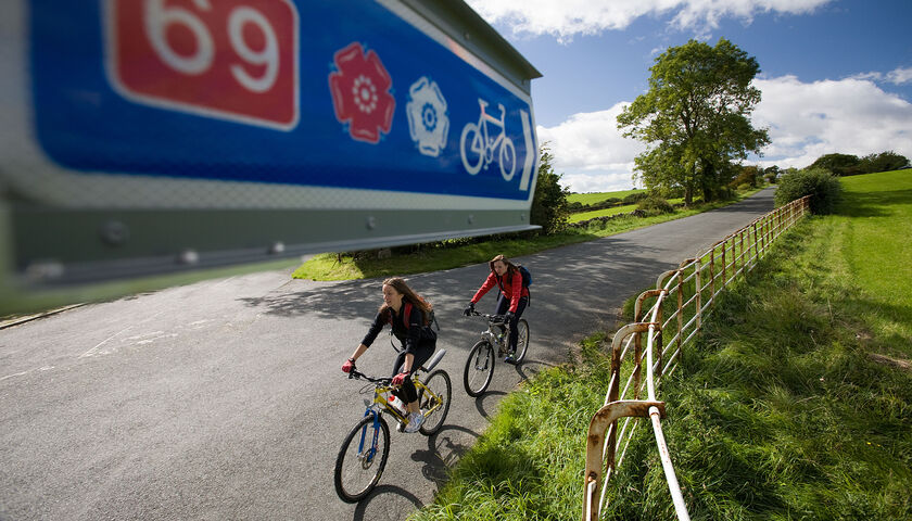 Two cyclists on a rural road outside Lancaster