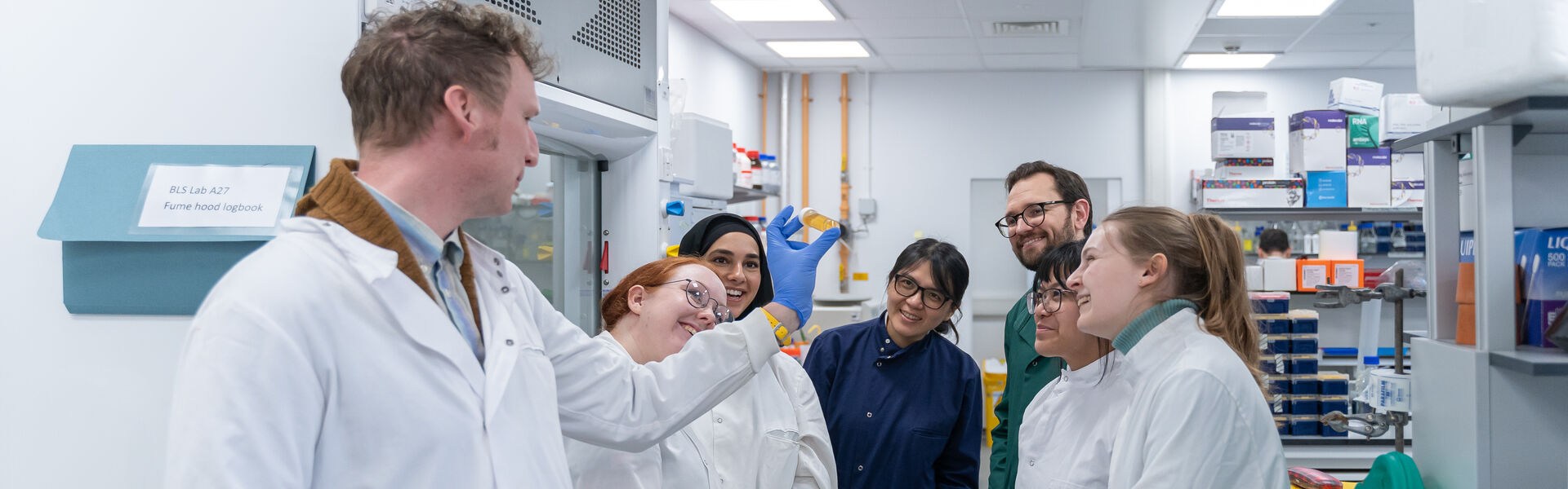 Public looking into microscope in the lab