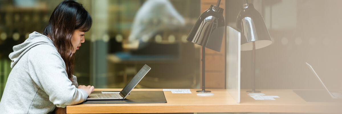 Two students are sat in the Learning zone on campus