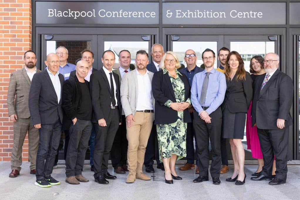 A group of people standing in front of Blackpool Conference and Exhibition Centre
