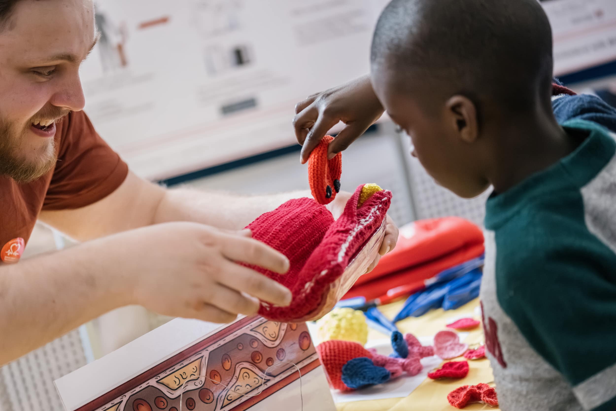 A young boy is shown a knitted model or an artery