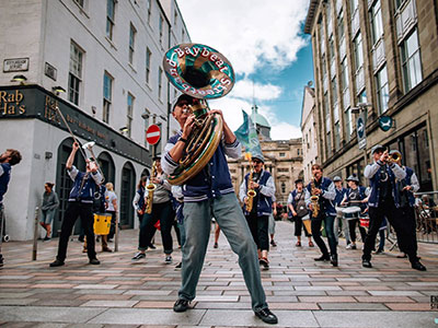 a band play brass instruments in the street