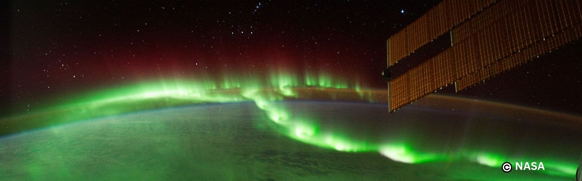 our planet from space with the northern lights shining green