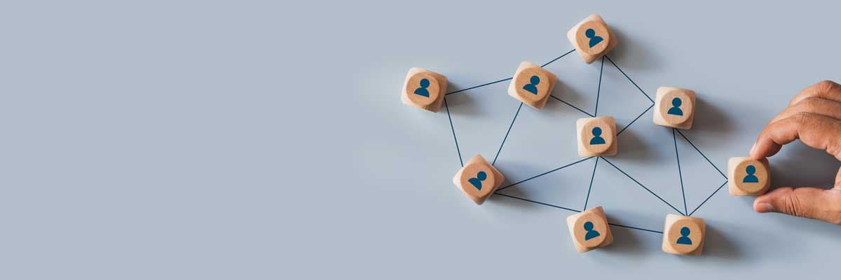 network structure with connected people icons on wooden blocks