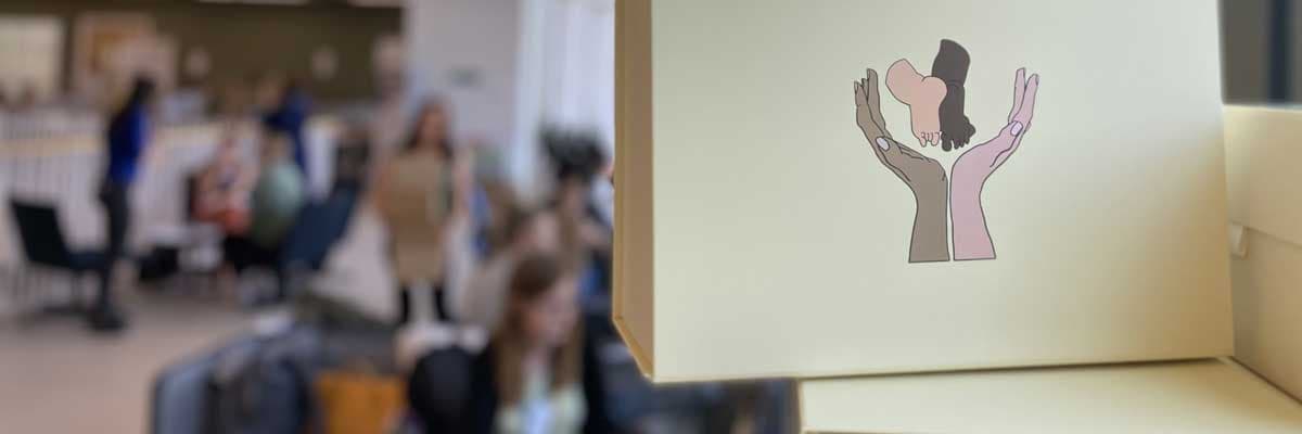 photo of a pile of hope boxes with people blurred in the background