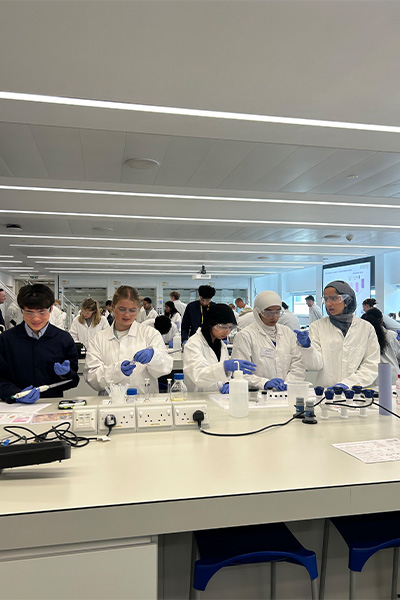 Students in labcoats doing experiments