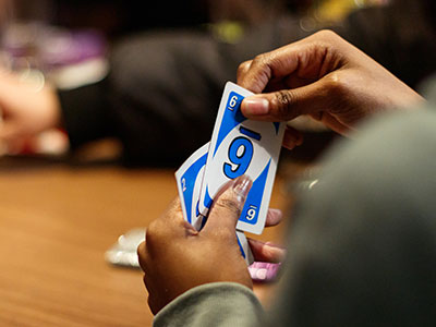 Person holding playing cards