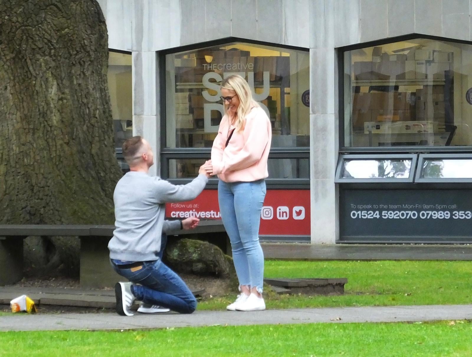 James Garside on bended knee proposing to Emma Wilson near the County oak tree