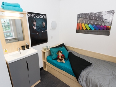 Bed with a plush toy on the mattress with a 