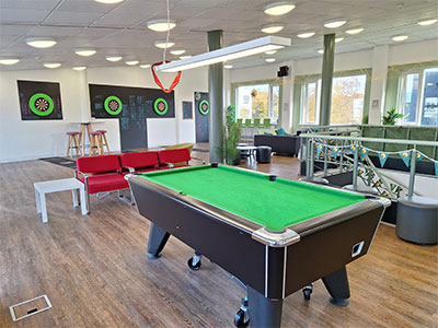 a pool table and dart boards