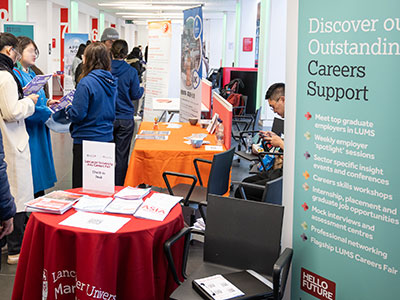 People talking at stall around a room