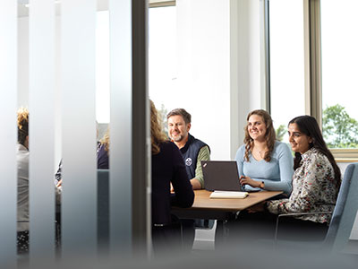 People sat around a table in a group