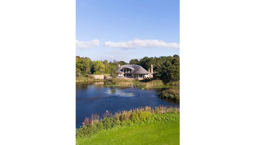 Forrest hills building with large lake in front