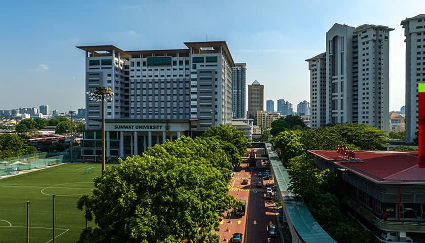 Suway University campus building with sports pitch outside