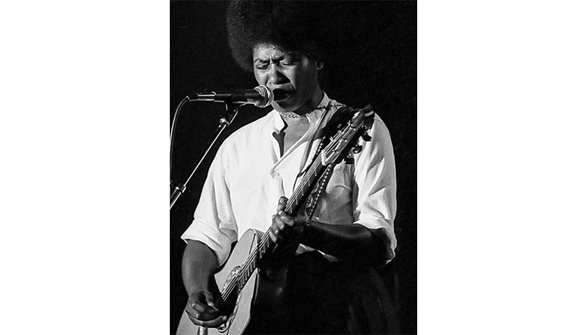 Joan Armatrading performing with a guitar