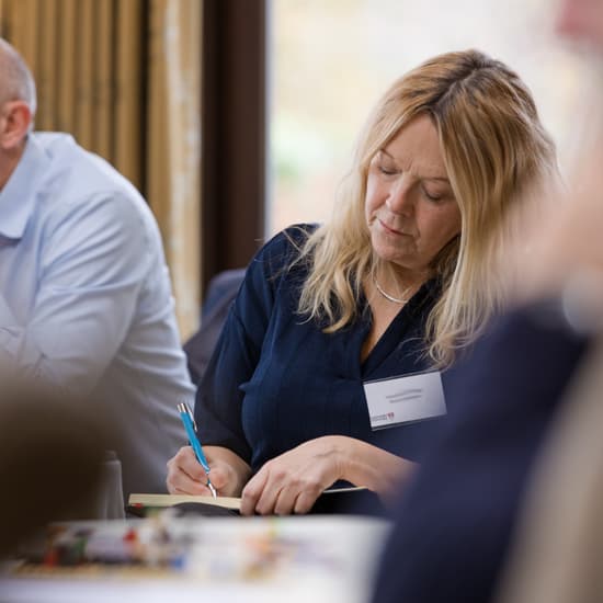 Three delegates in discussions during a Lancashire Cyber Security Workshop. 