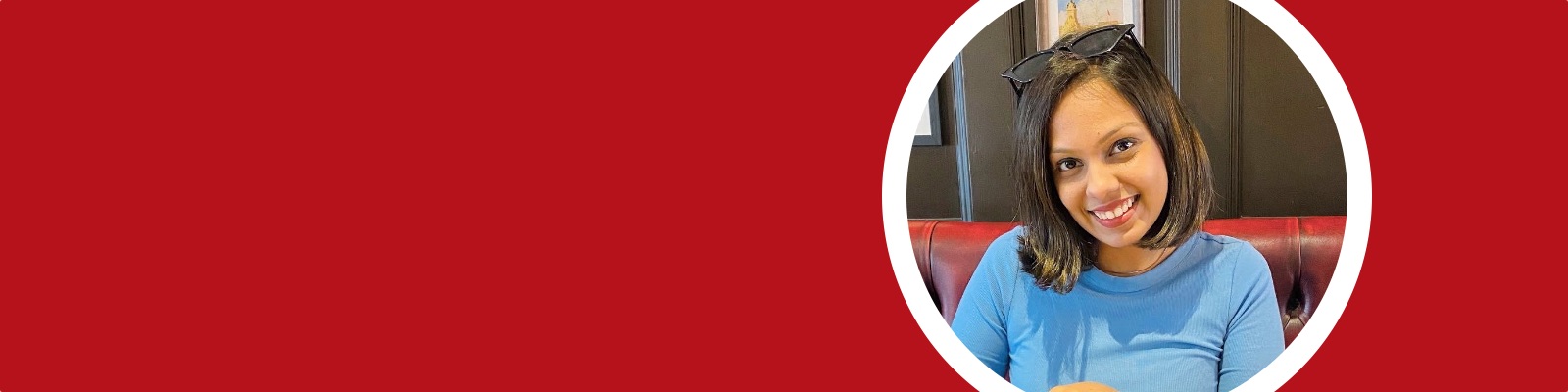 Aishwarya sits at a table, pouring tea from a teapot.