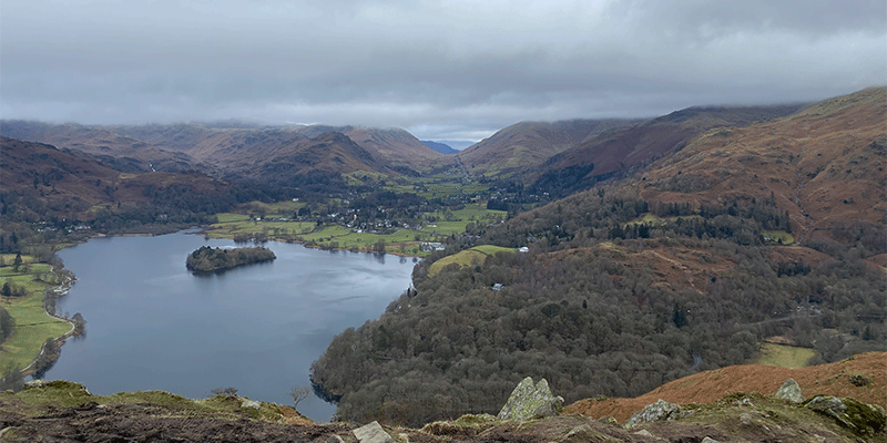 View from half-way up a mountain in the Lake District, showing a lake at the bottom.