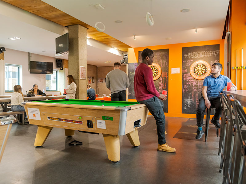Students sat chatting in Fylde College's bar near the pool tables.