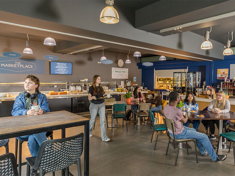 Students eating and chatting at The Marketplace on campus.