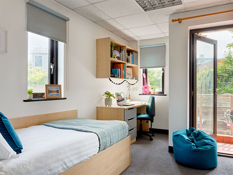Student accommodation room, with a single bed and desk area.