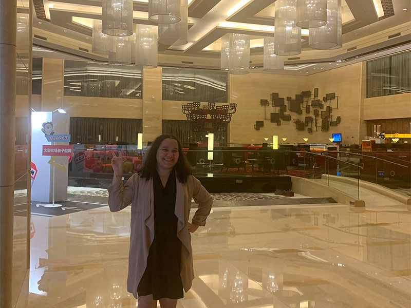 Lyea stood smiling in the hotel reception.