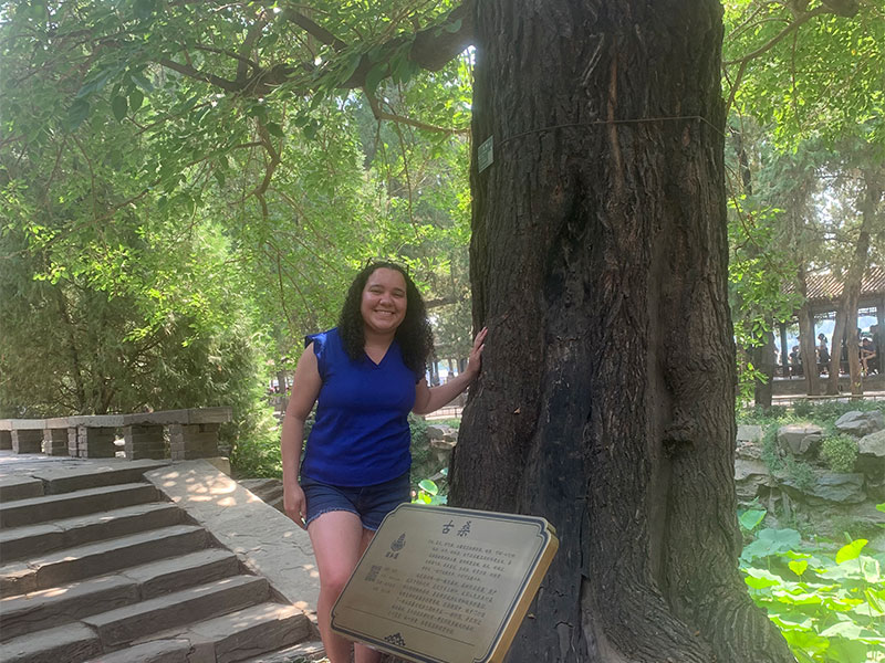 Lyea standing next to a tree in Summer Palace.
