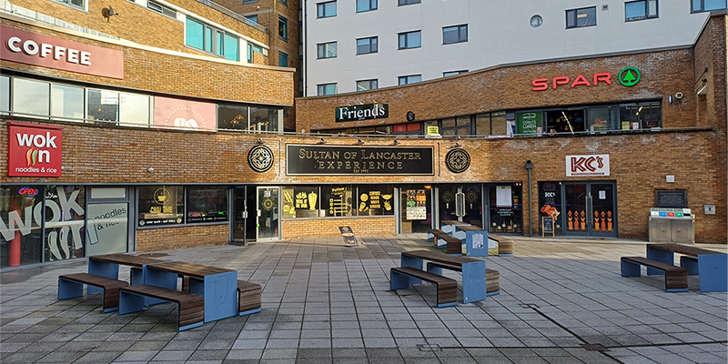 Shops and seating areas at Edward Roberts Court, Lancaster University.