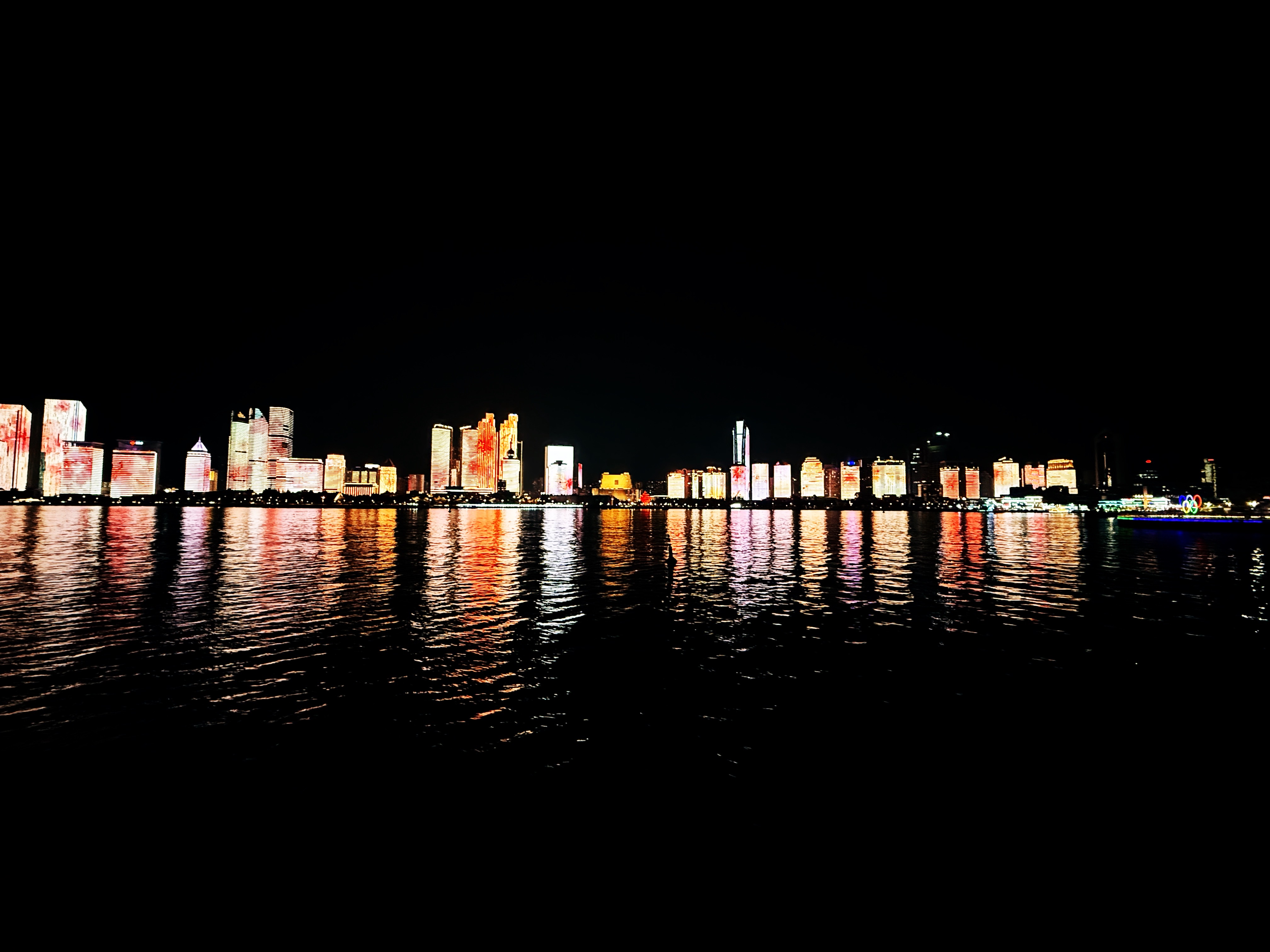 A view from the harbour of modern skyscrapers trace along the coastline in Qingdao, China.