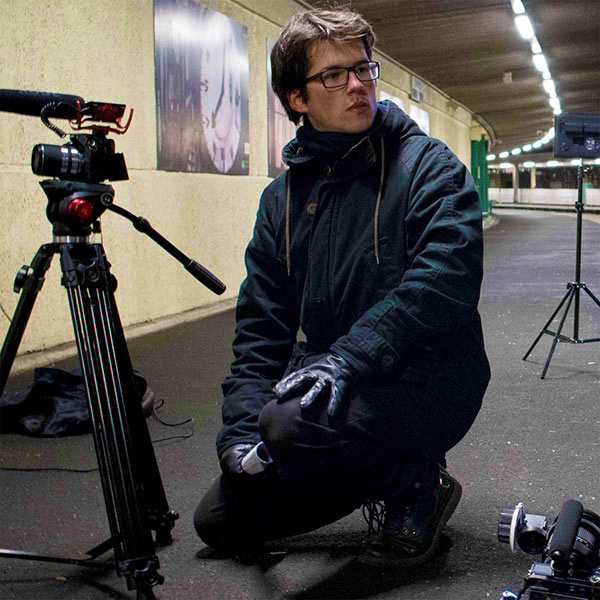 Male student with a video camera