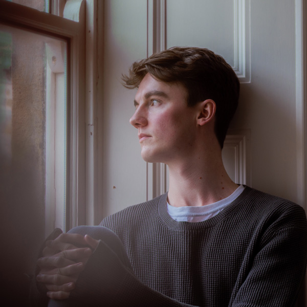 Head and shoulders picture of Digital Ambassador Joe looking out of a window