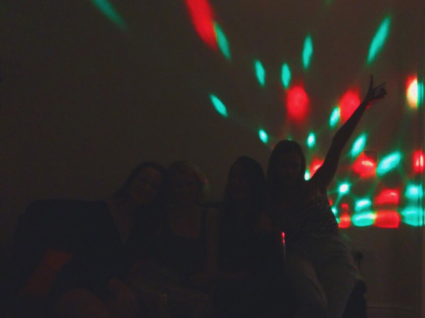 Students sitting in front of disco lights