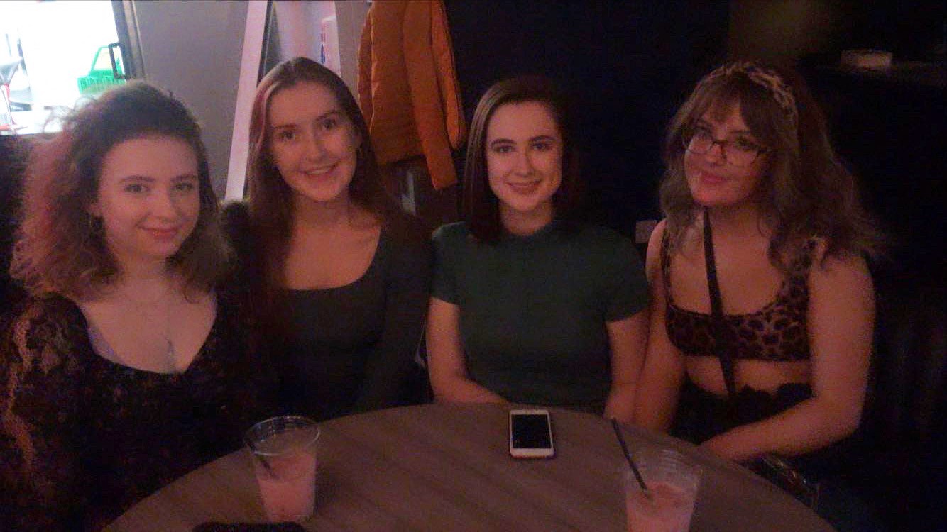 four female students sitting at a table