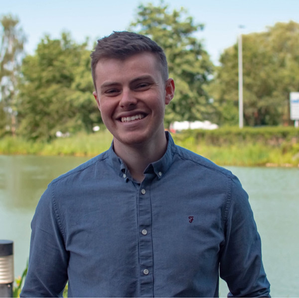 Head and shoulder picture of Digital Ambassador Chris standing in front of some open water