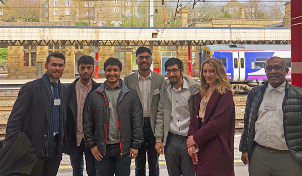 A group of 6 male and 1 female student on Lancaster train station platform
