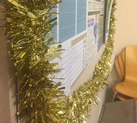 A noticeboard surrounded by gold tinsel