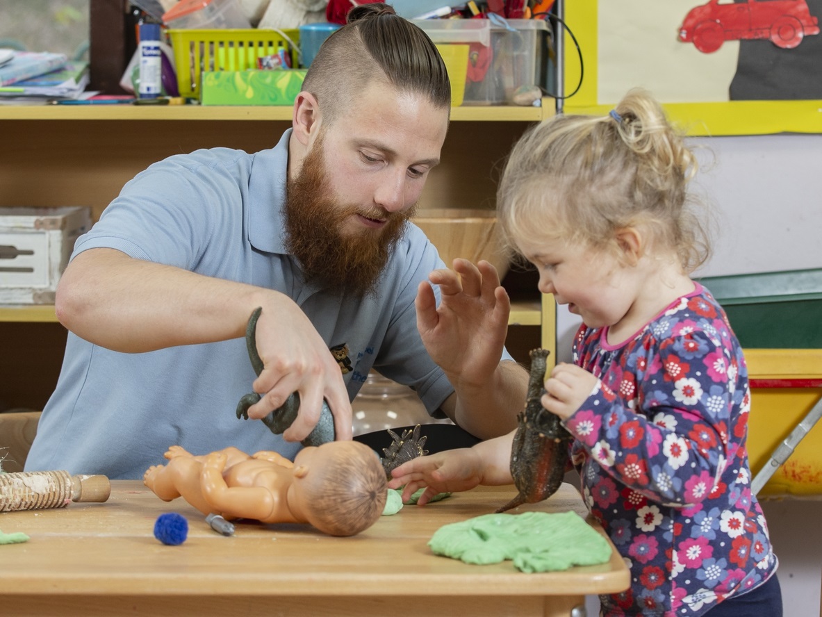 Preschool worker and child