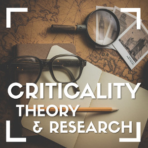 Eye glassses, magnifying glass, notebook, pen and postcards placed on an old map