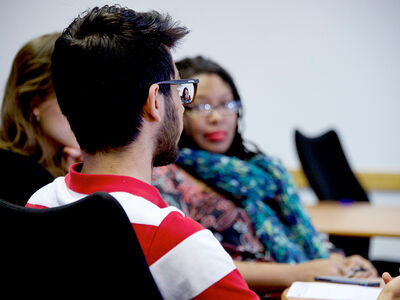 International students in a classroom, conversing. 