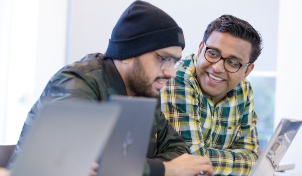 Staff sitting round a table having a discussion