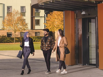 Three students coming out the door of the Confucius Institute