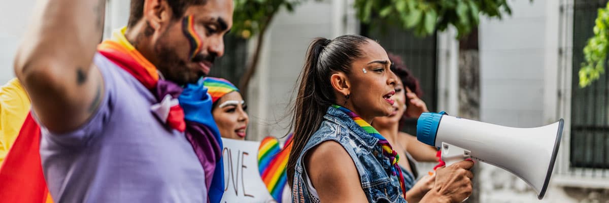 LGBTQIA+ people marching during social movement protesting outdoors