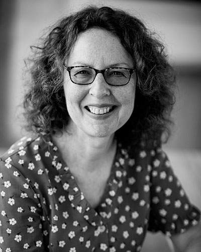 Gillian Whitworth wearing glasses smiling