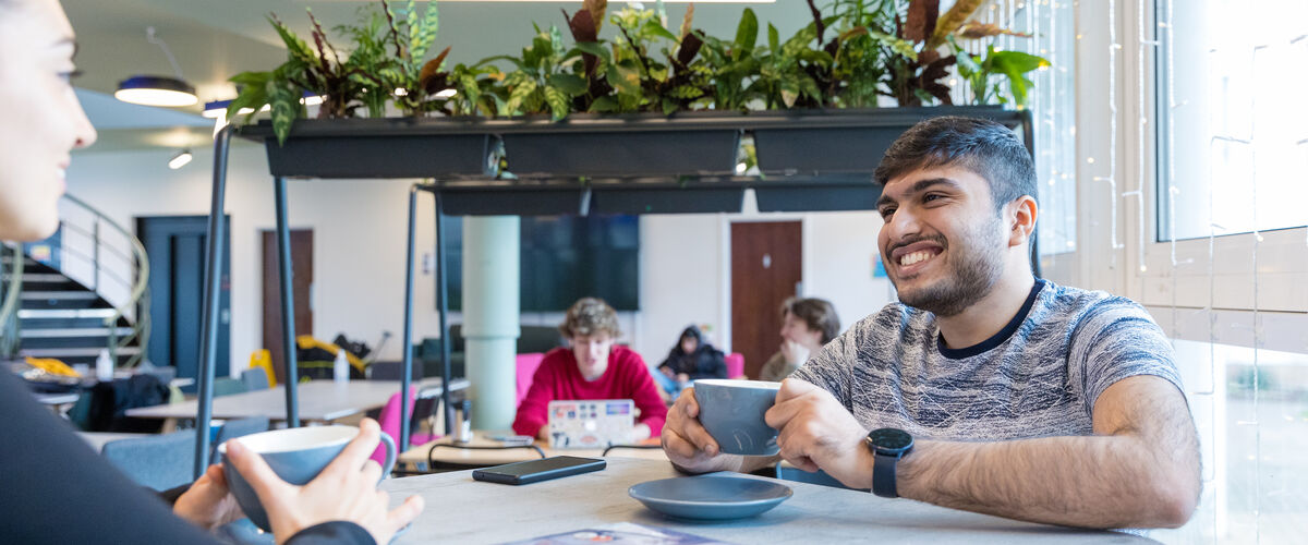 Two students drinking coffee. 