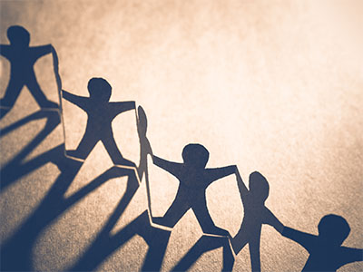 Paper people holding hands