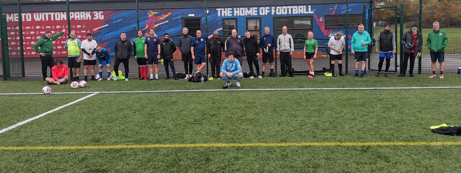 Group of people on football pitch 