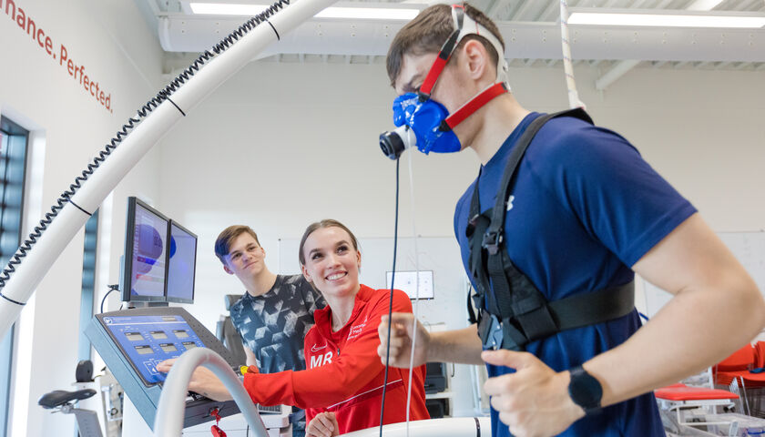 A student running on a treadmill with an oxygen mask on. 
