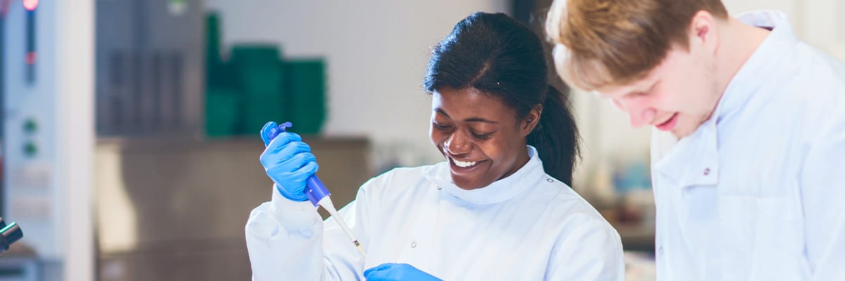 Two students in a chemistry laboratory.