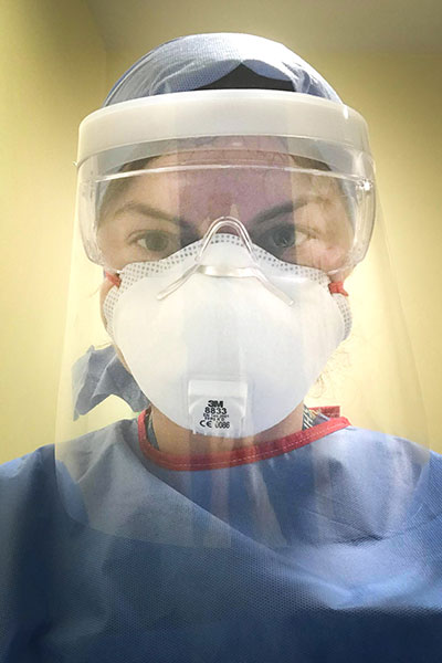 A young woman wearing medical personal protective clothing